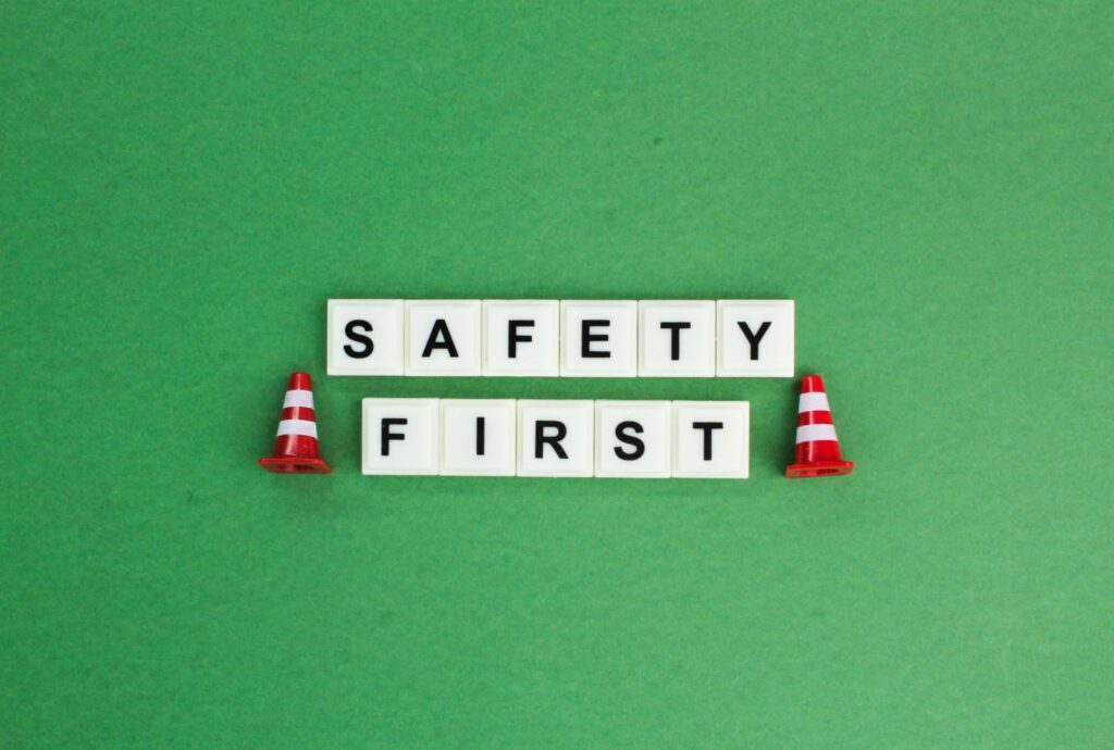 Words “safety first” next to cones.
