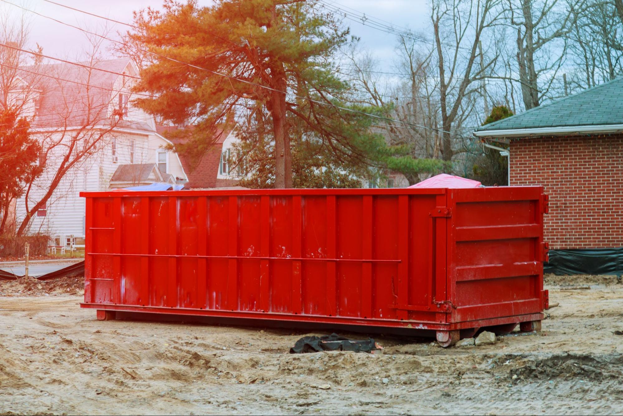 Roll-off dumpster next to a home.