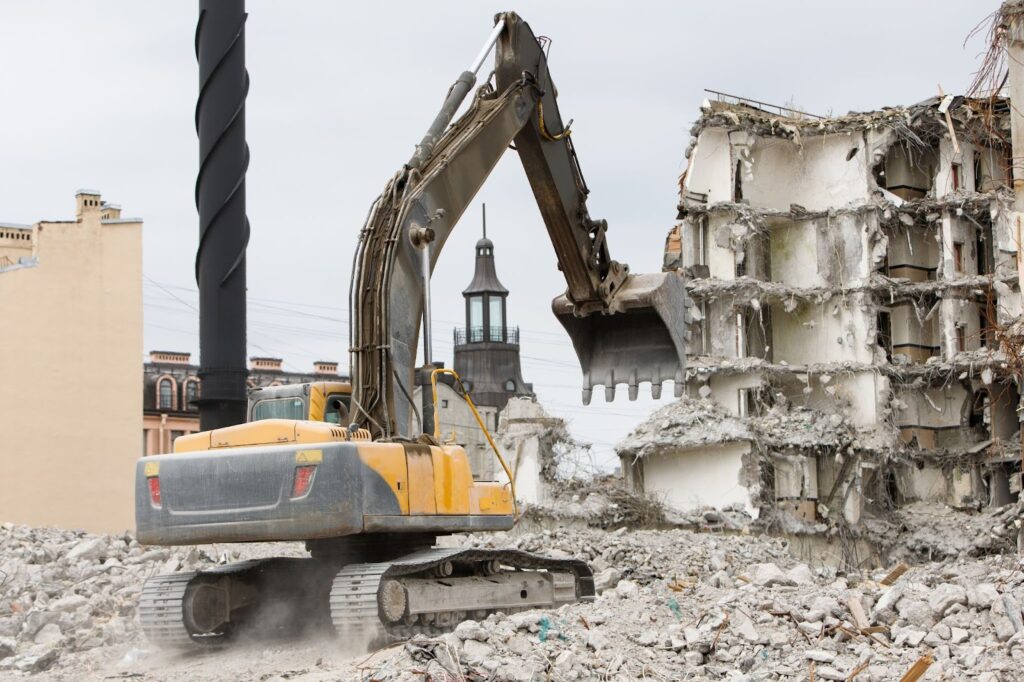 An excavator demolishes an old hotel during a construction job.