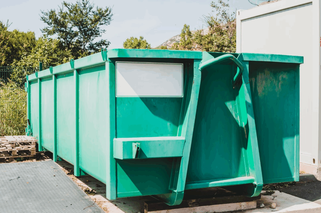 A large teal dumpster.