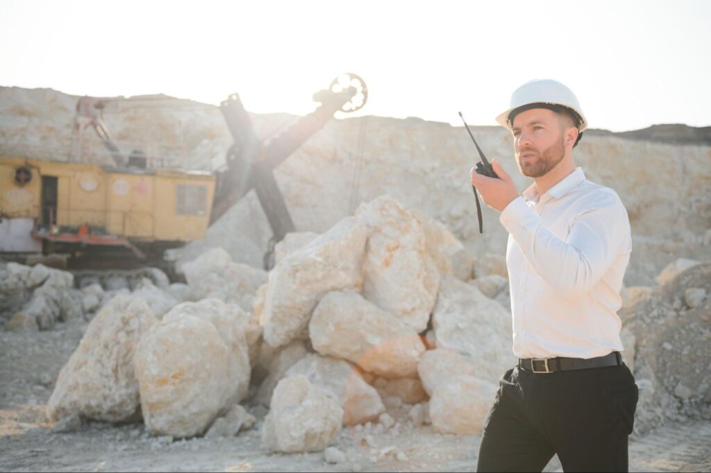 A demolition contractor uses a walkie-talkie to give instructions.