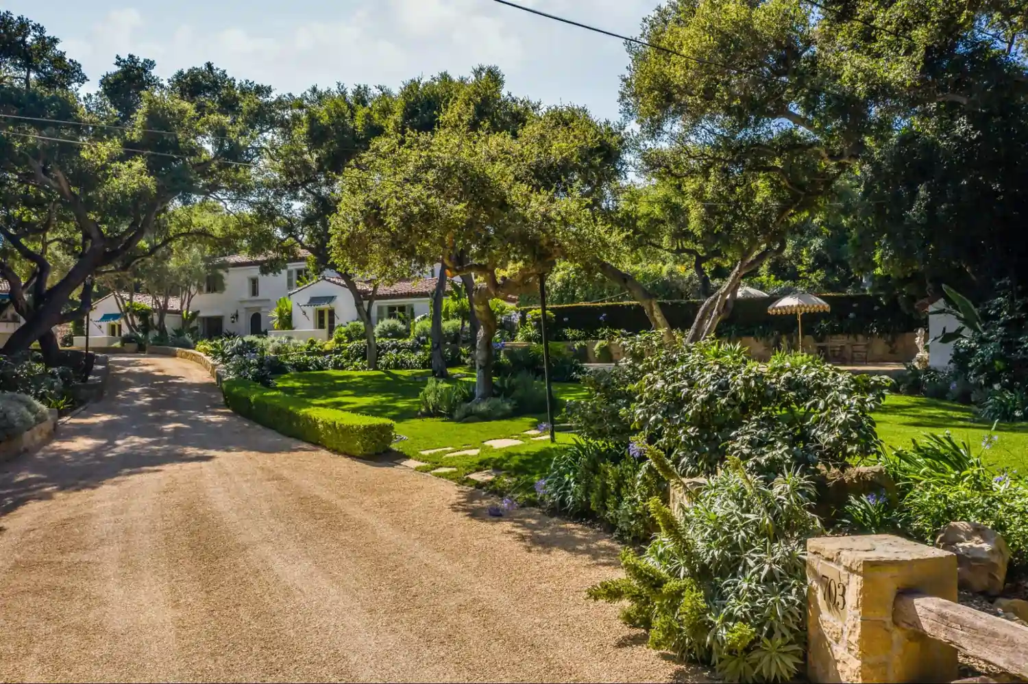 Gravel driveway leading to a home.